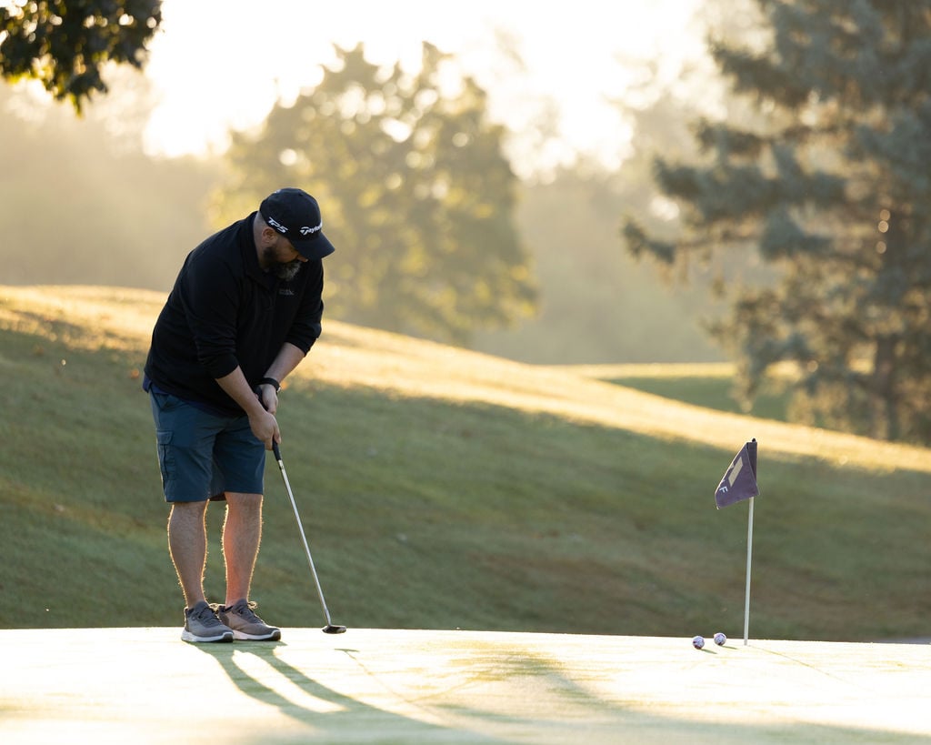 Participant putting during the IGNITE 25 golf tournament at a Golf Course