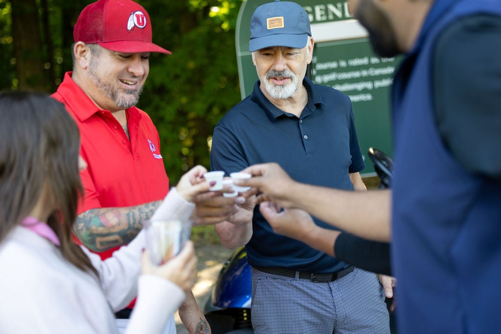 Golfers share a celebratory toast on the course at the IGNITE 25 golf tournament, part of Techdinamics' 2025 user conference.