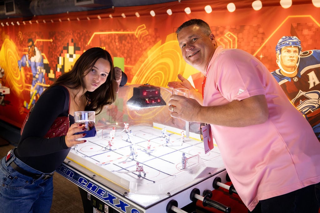 Two IGNITE 25 attendees playing tabletop hockey at the Hockey Hall of Fame