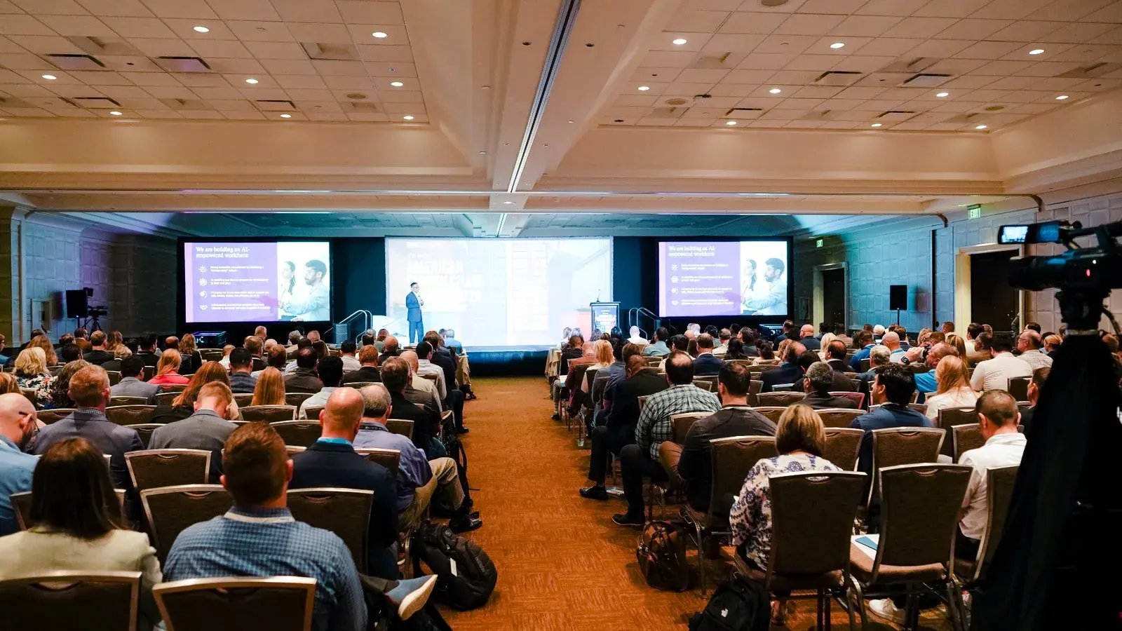 Large audience attending a supply chain technology presentation at the American Supply Chain Summit.
