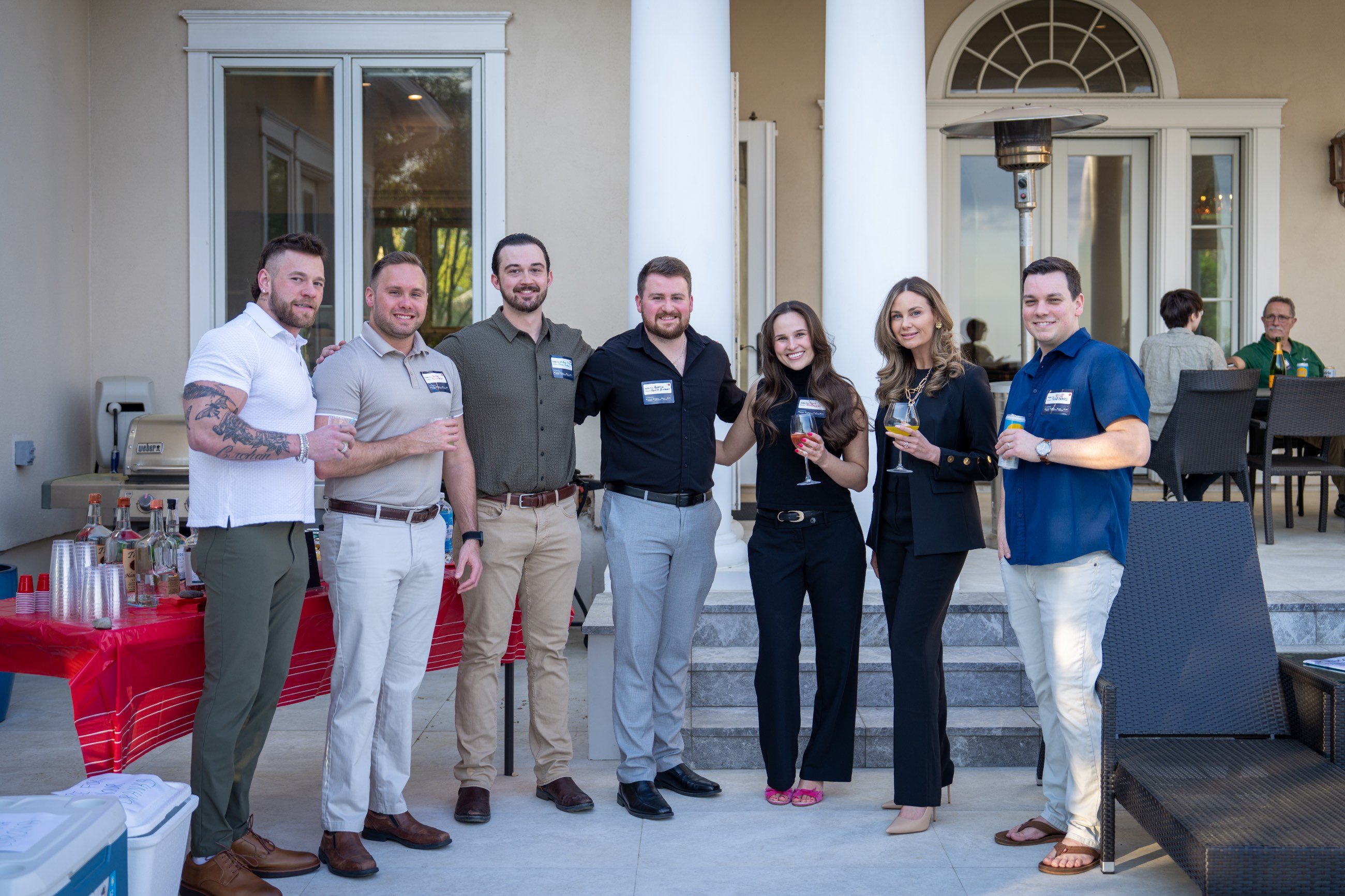 Seven guests posing for photos at the party.