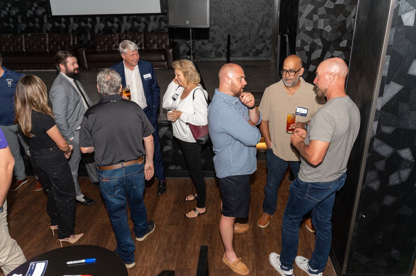 Attendees mingle and small groups converse
