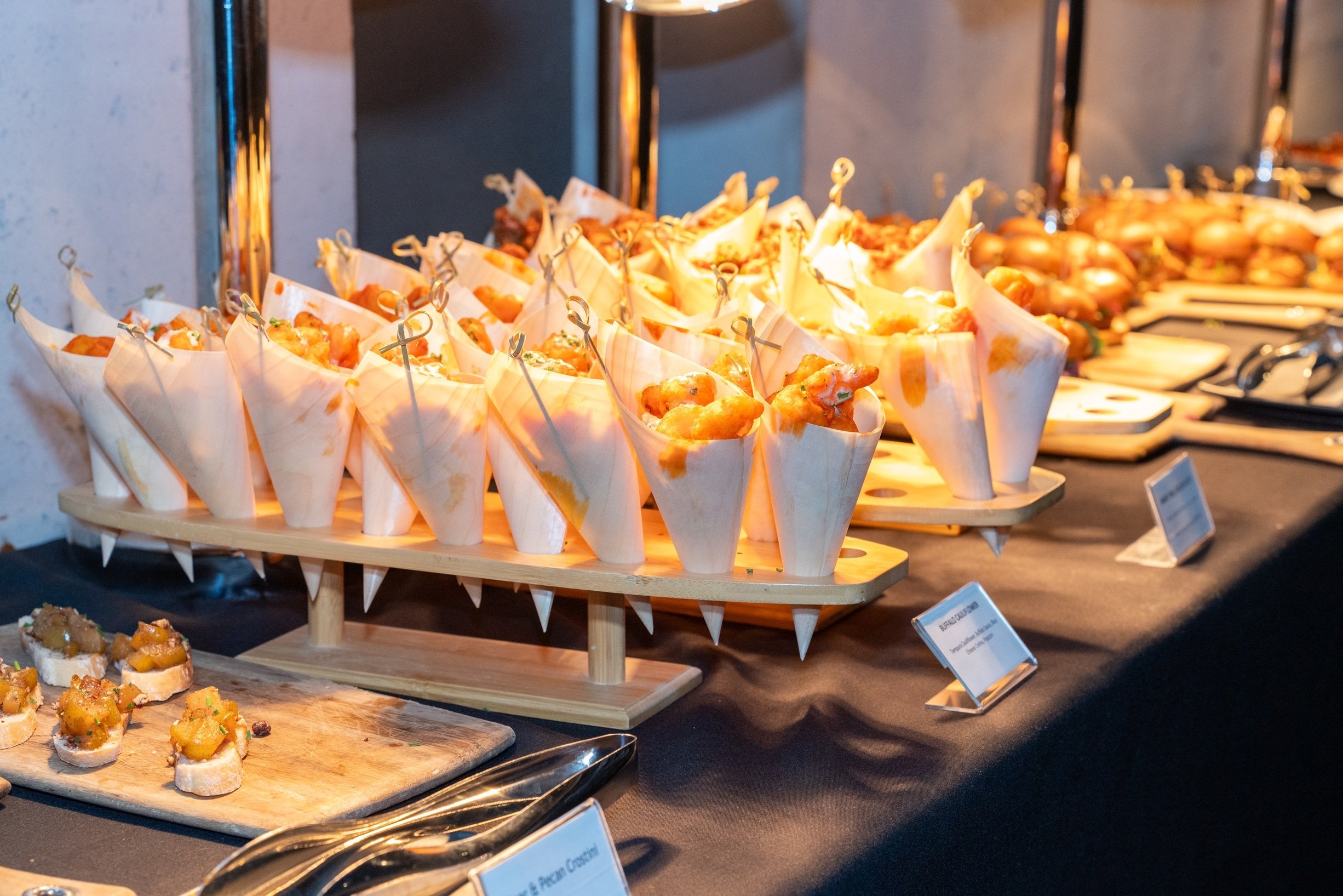 Buffet of appetizers and small bites available for attendees during an industry networking reception.