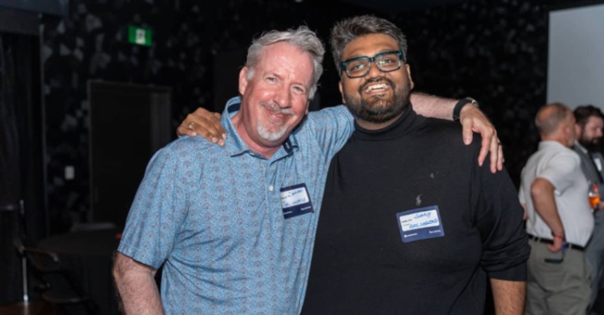 Two attendees posing together during a logistics and technology networking event.