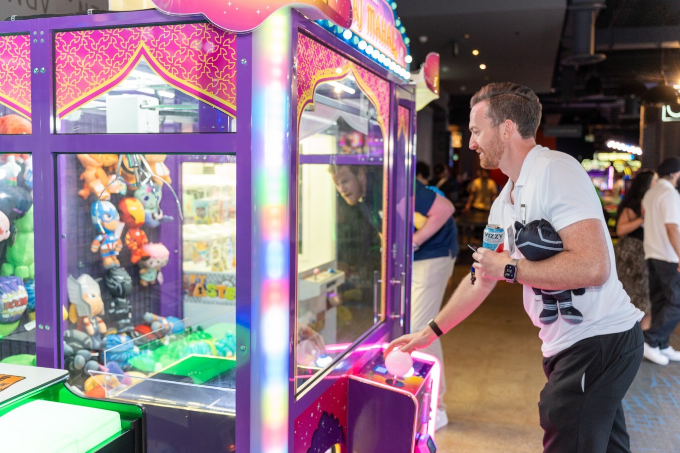 An attendee playing the claw machine