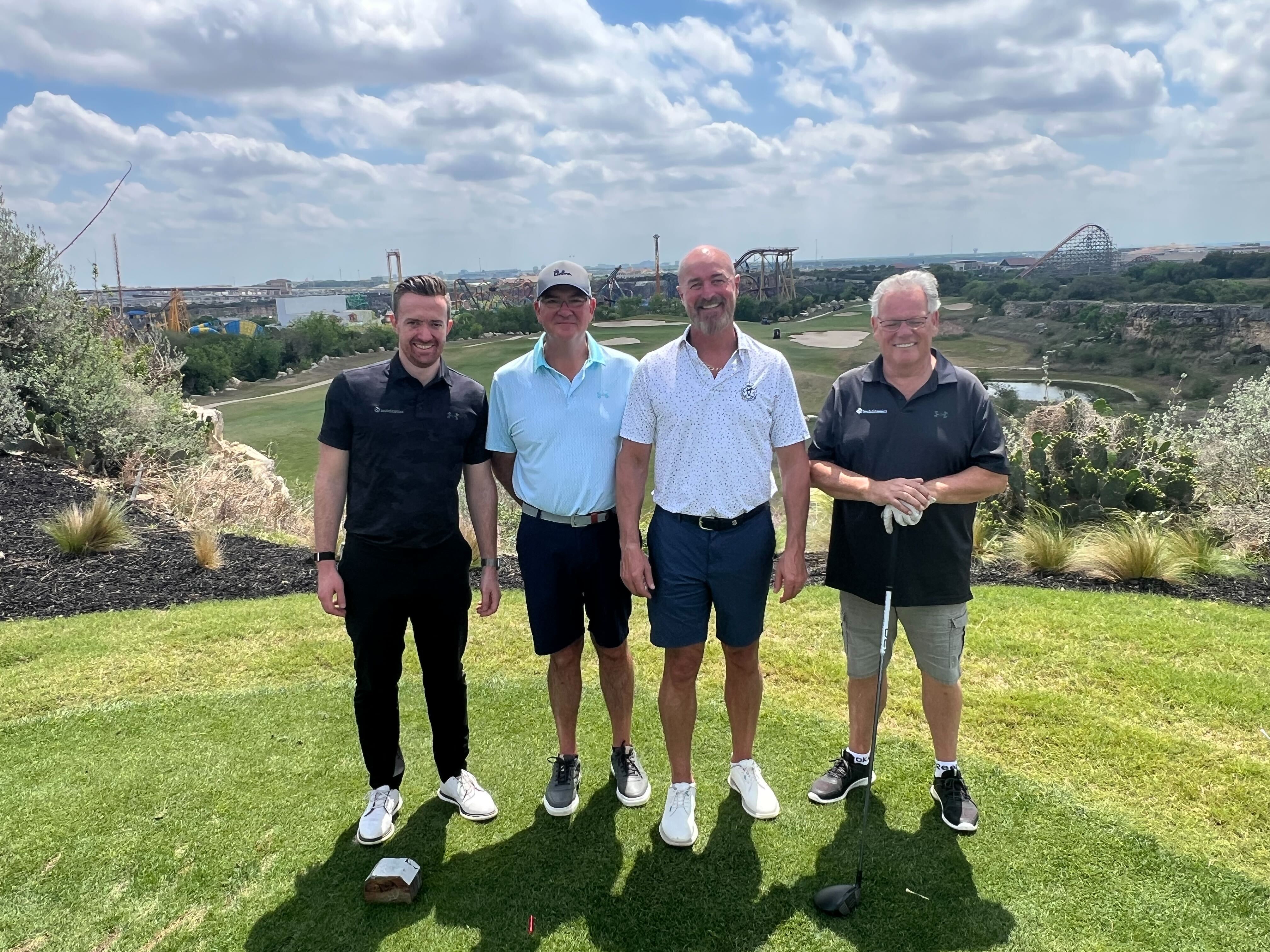 Golf players pose at the court
