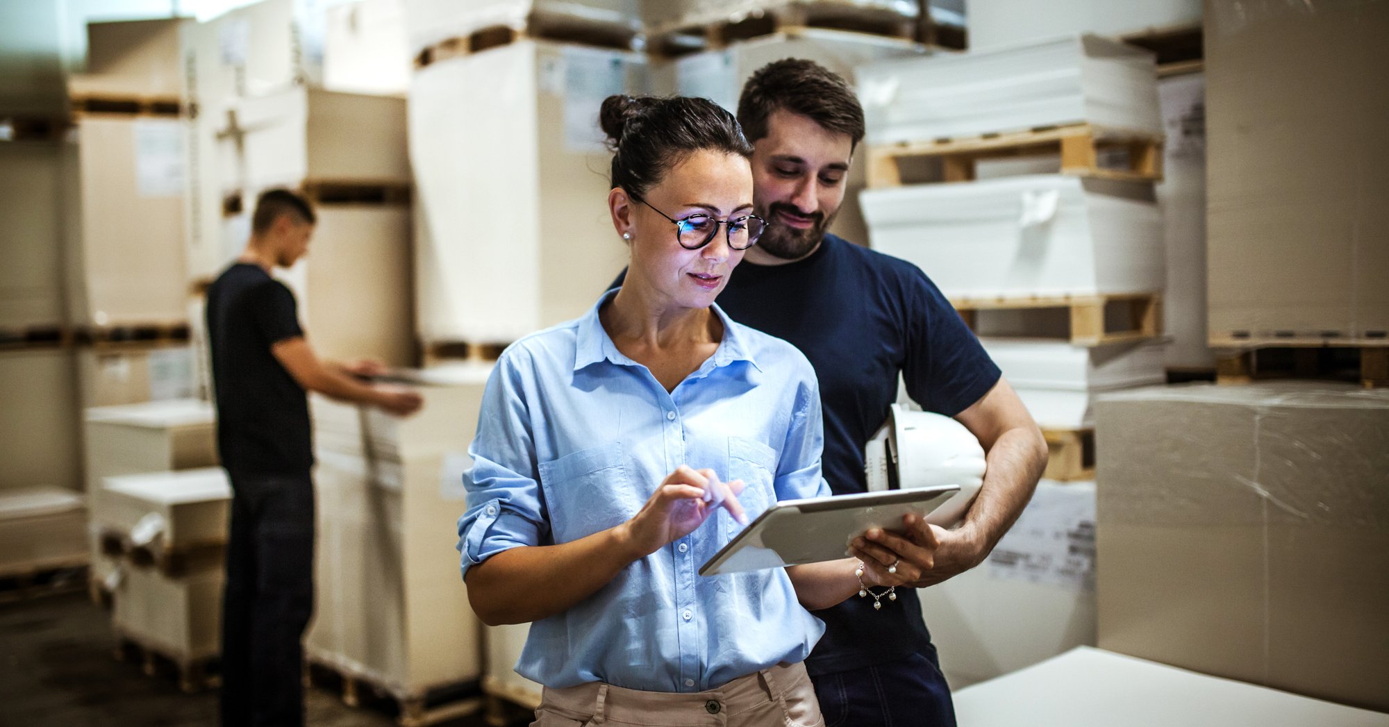 Warehouse operations manager monitors fulfillment with a colleague in an enterprise distribution center. Warehouse operations manager monitors fulfillment with a colleague in an enterprise distribution center.