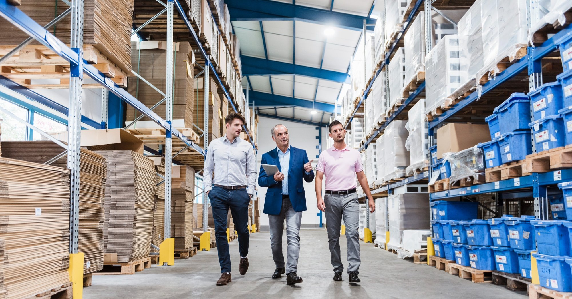 Three businessmen walking around a warehouse formally dressed. Three businessmen walking around a warehouse formally dressed.